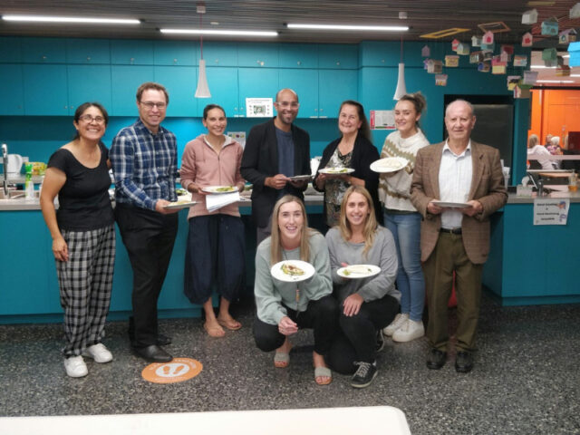 group holding plates with food